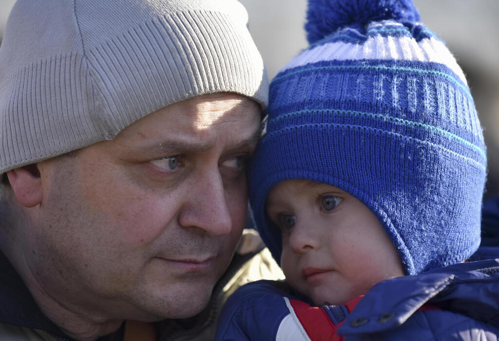 A father and son evacuated from a village outside Kyiv on Tuesday 