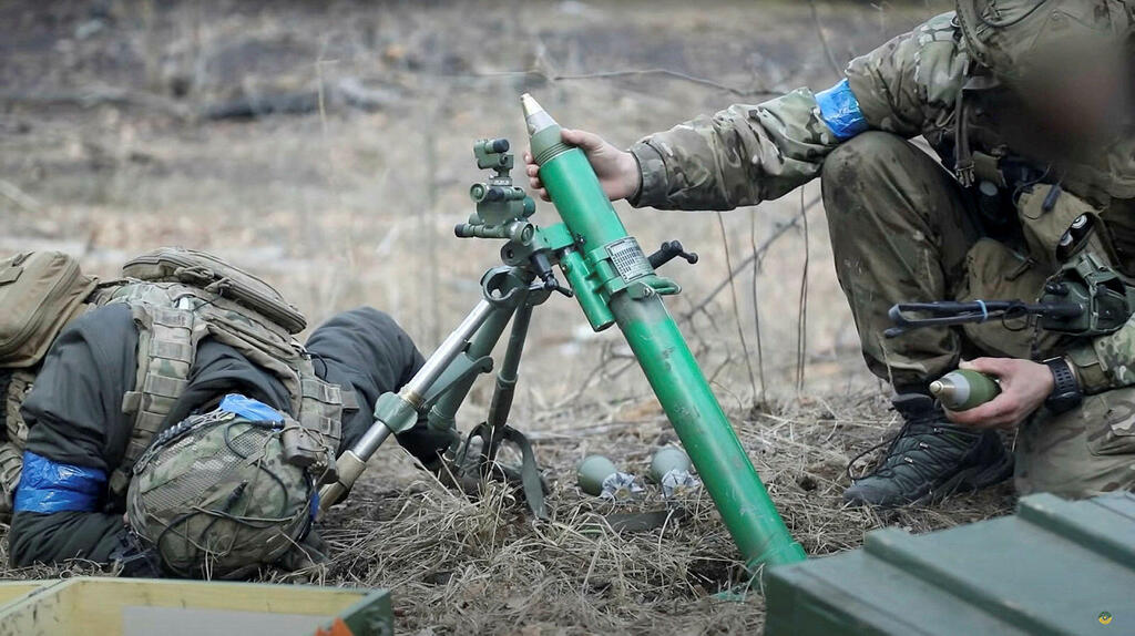 Ukrainian soldiers fire a mortar, in footage said to show combat with Russian troops near the Kyiv region 