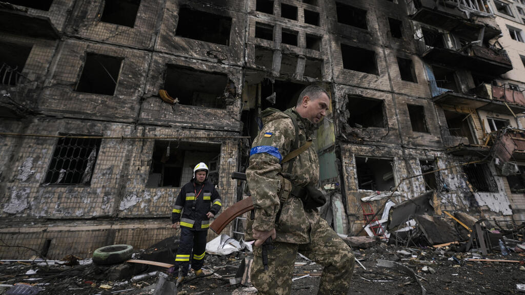 A Ukrainian soldier walks by a building damaged by Russian shelling in Kyiv (Photo: AP) A Ukrainian soldier walked by a building destroyed by Russian bombing in Kyiv