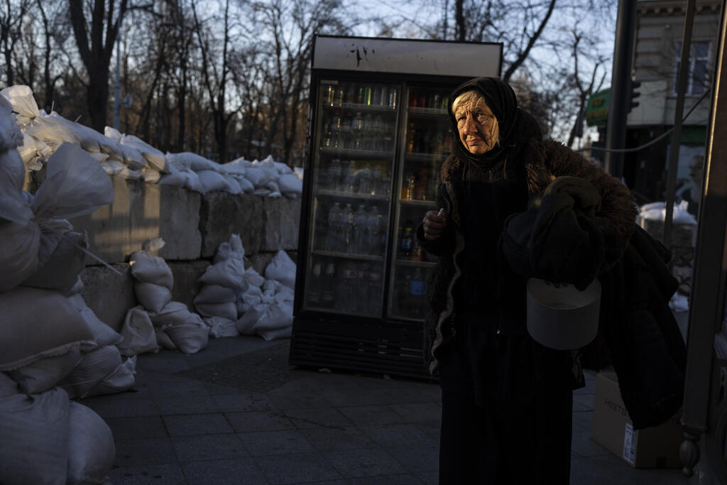 A woman passes by sandbags in Odessa 