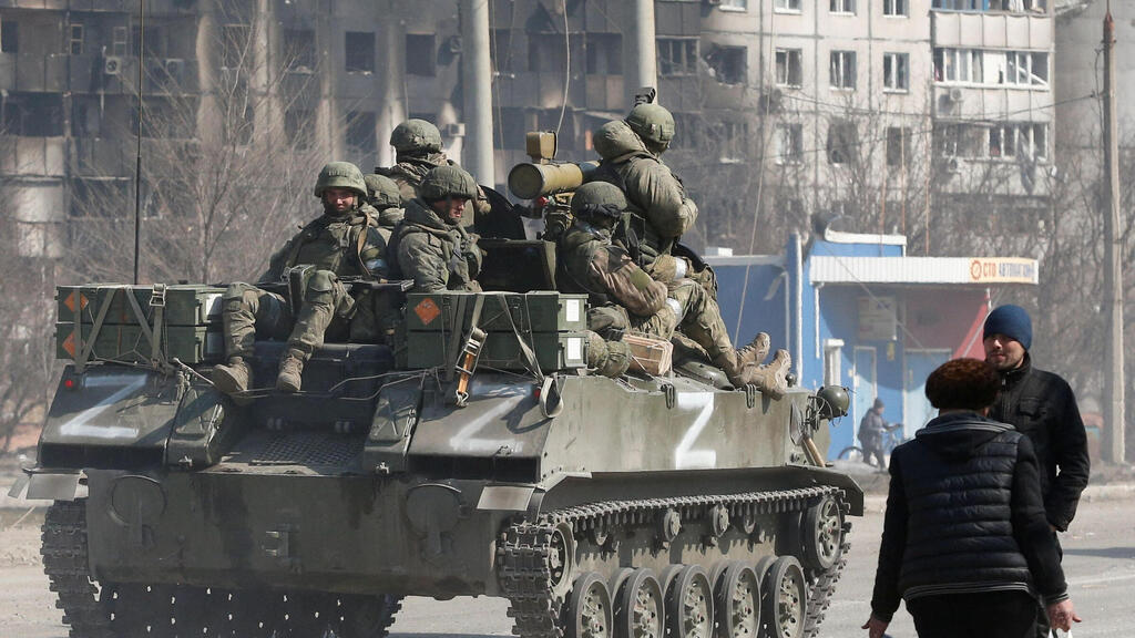 Pro Russian troops on a tank in Mariupol on Thursday 