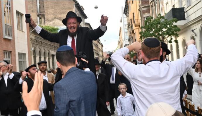 Rabbi Shmulik Oirechman dancing on the shoulders of other Jews at the opening of the Vorosmarty Street Synagogue in Budapest, Hungary, Aug. 27, 2021 