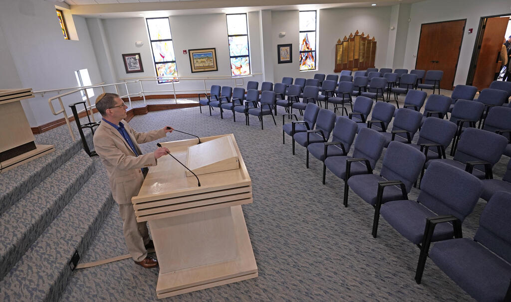 Rabbi Charlie Cytron-Walker adjusts the microphones while testing the sound system at Congregation Beth Israel in Colleyville, Texas 