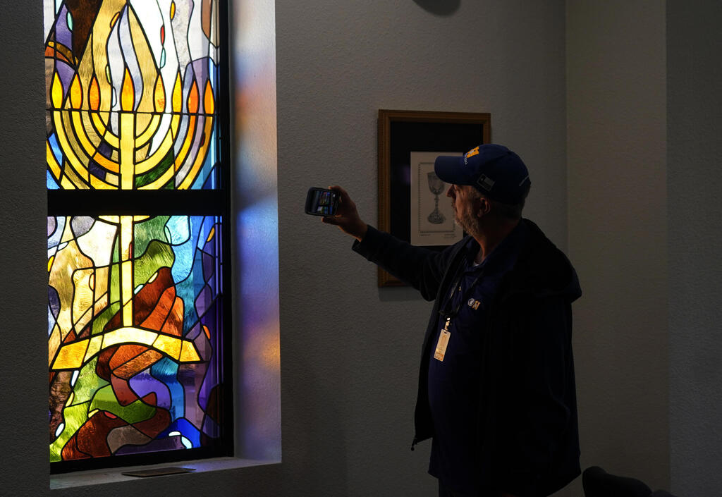 A stained glass window that once had bullet holes is now repaired at Congregation Beth Israel 