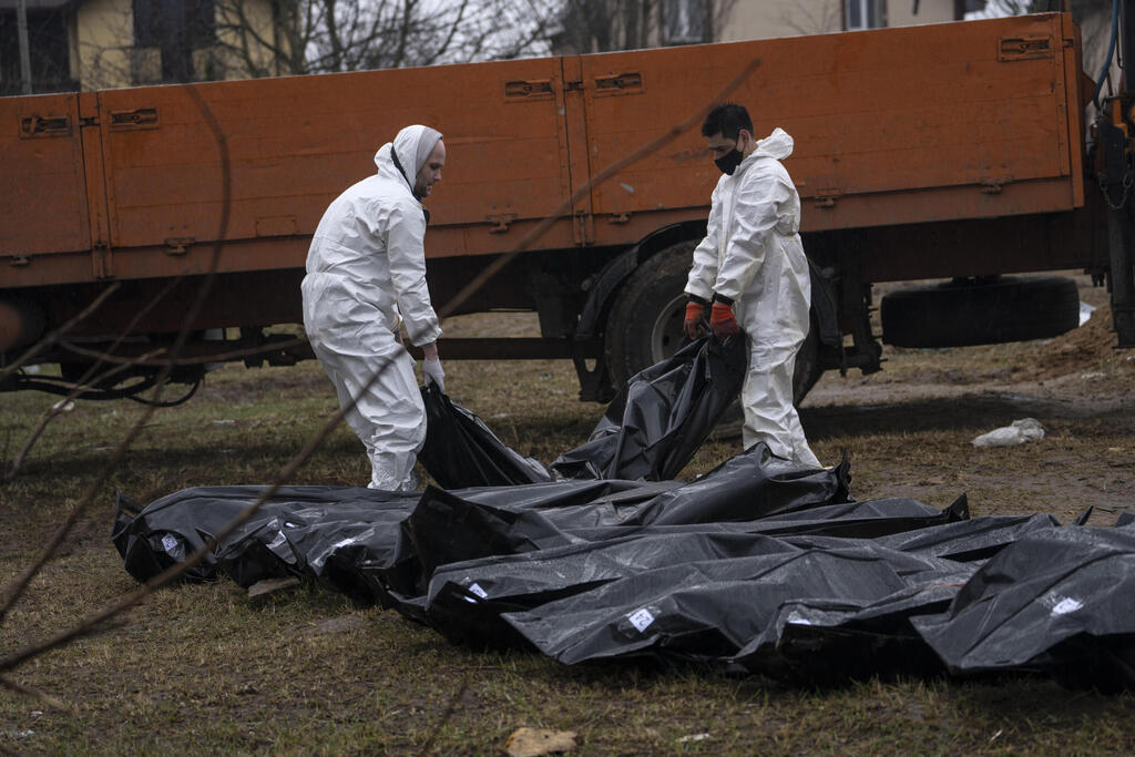 Bodies of Ukrainians taken from a mass grave near Kyiv for identification on Sunday 
