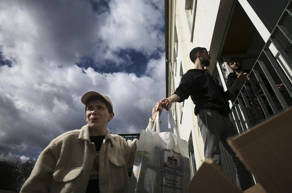 From left, Danya, 21, Gabriel, 21 and Borden, 17 all refugees from Odesa, Ukraine help to deliver bags with food to needy people during preparations for the celebration of Jewish Passover at the Chabad Jewish Education Center in Berlin, Germany, April 7, 2022 (Photo: AP) From left, Danya, 21, Gabriel, 21 and Borden, 17 all refugees from Odesa, Ukraine help to deliver bags with food to needy people during preparations for the celebration of Jewish Passover at the Chabad Jewish Education Center in Berlin, Germany, April 7, 2022