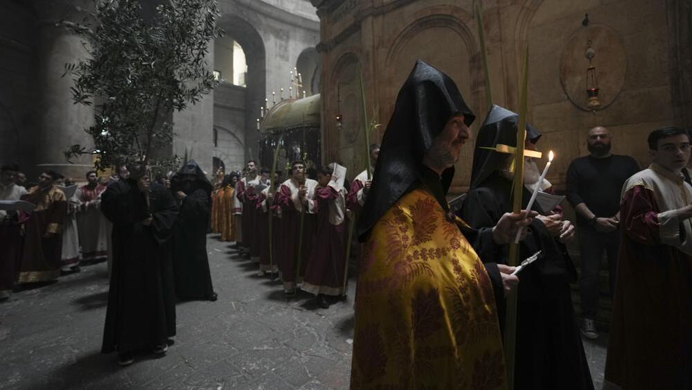 Orthodox Christian clergy marks Palm Sunday at the Church of the Holy Sepulchre, Sunday, April 17, 2022 