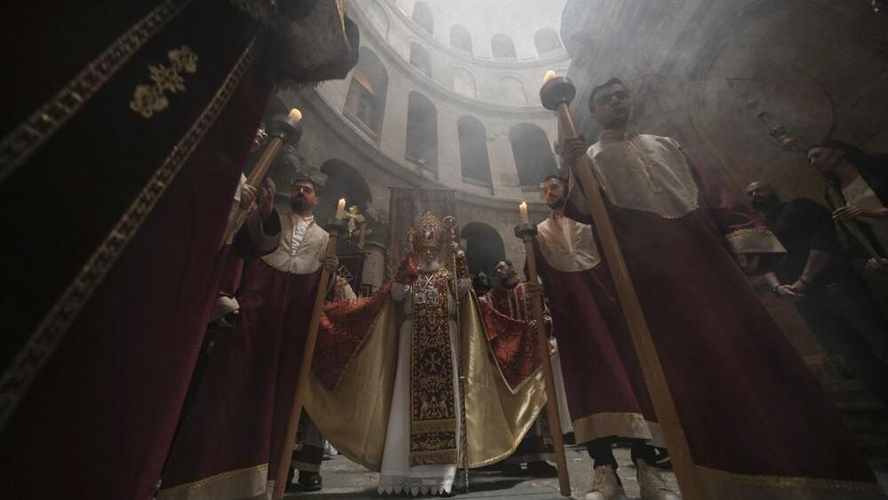 Orthodox Christian clergy marks Palm Sunday at the Church of the Holy Sepulchre, a place where Christians believe Jesus Christ was crucified, buried and resurrected, in Jerusalem, Sunday, April 17, 2022