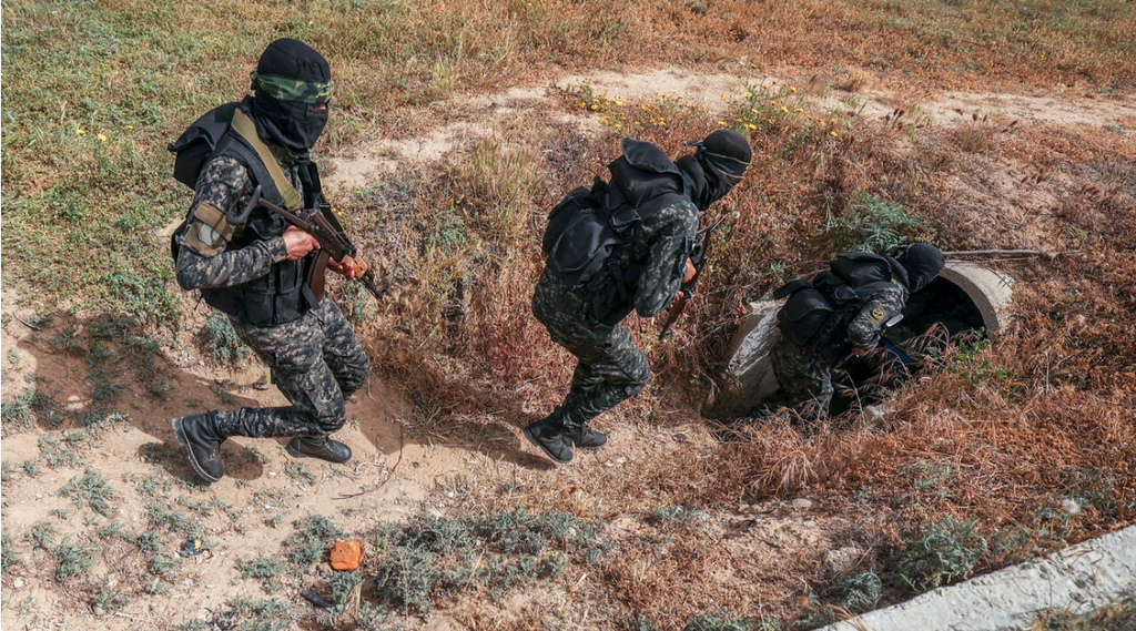 Members of the Palestinian Islamic Jihad militant group enter a tunnel in the Gaza Strip, during a media tour amid escalating tensions with Israel