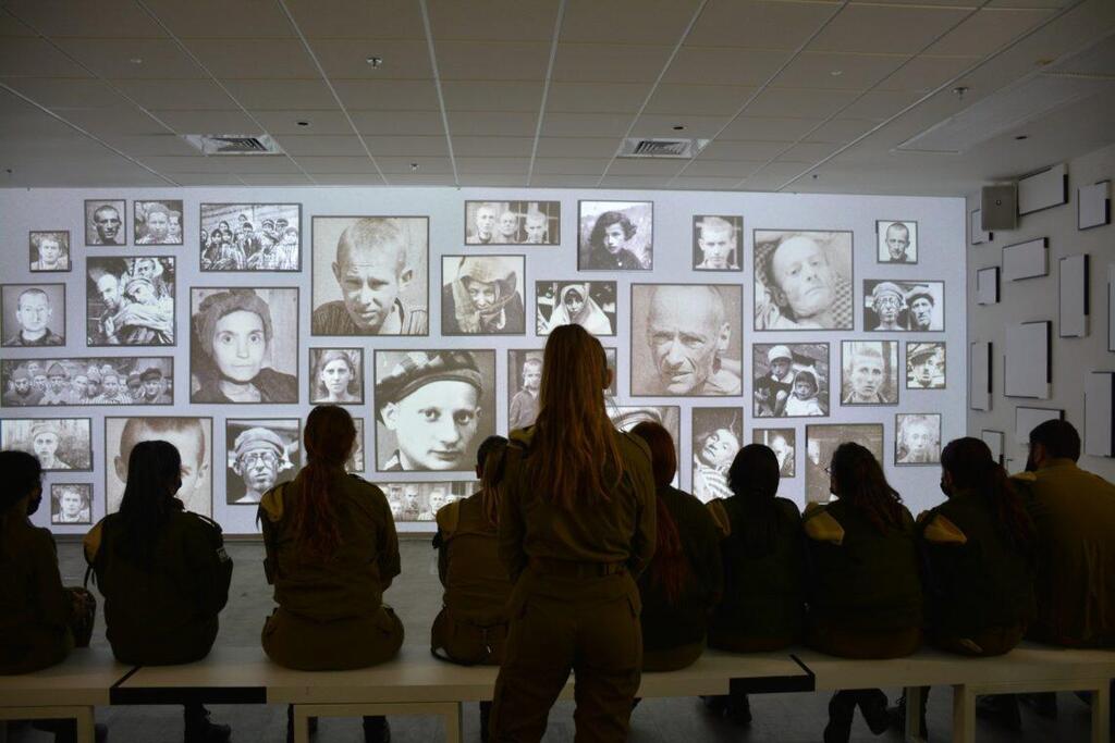 A group of IDF soldiers watch a guided tour through the “Before My Very Eyes” exhibition