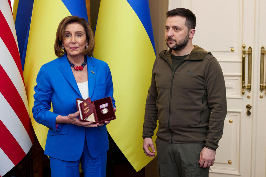 President of Ukraine Volodymyr Zelensky (R) presents the Order of Princess Olga to US Speaker of the House of Representatives Nancy Pelosi in Kyiv on Sunday 