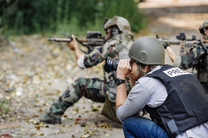 A photographer covering troops during fighting 