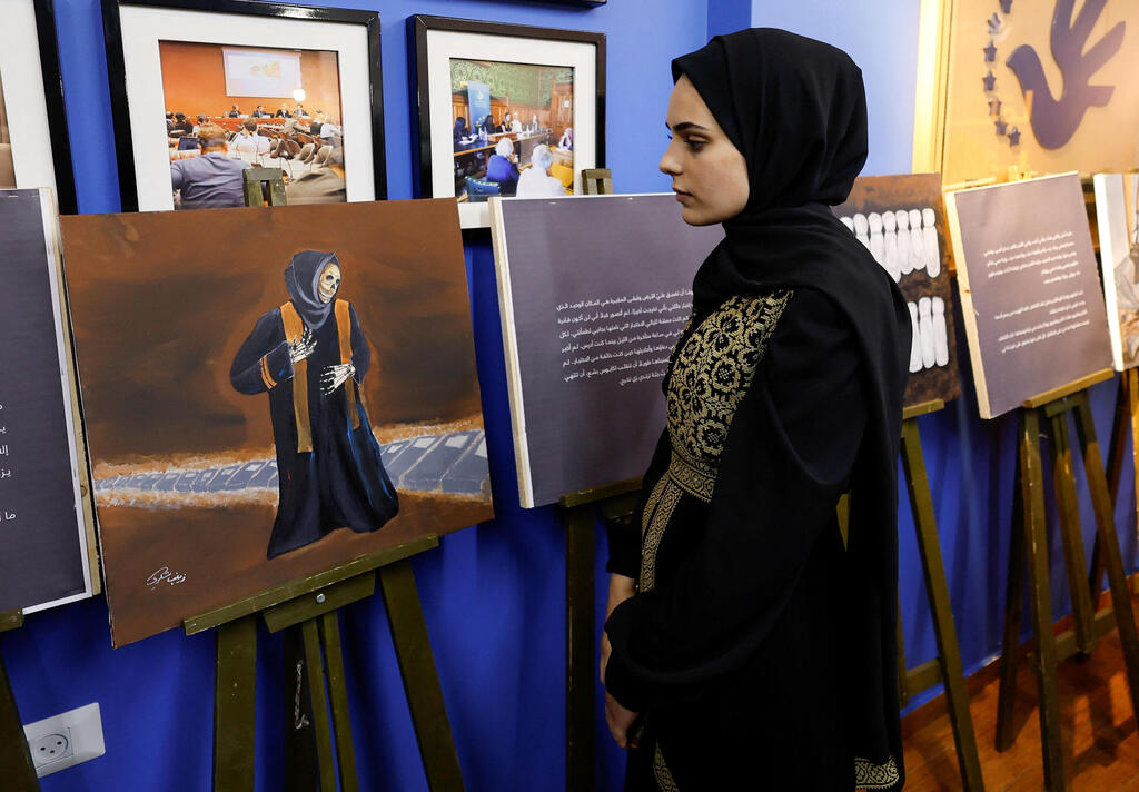 Zainab al-Qolaq, 22-year-old Gazan artist, exhibits her paintings in in Gaza City May 24, 2022