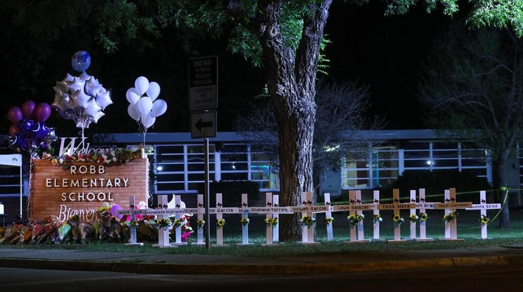 Crosses sit outside of Robb Elementary School in Uvalde, Texas, after a gunman killed 21 people inside 