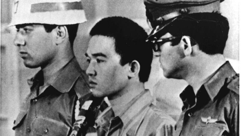 Japanese terrorist Kozo Okamoto, center, surrounded by guards, listen in a Lod courtroom, as a guilty verdict is delivered, on July 17, 1972, 