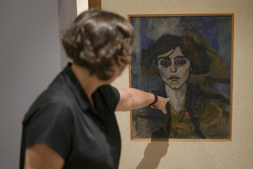 Inna Berkowits, an art historian at the Haifa University's Hecht Museum explains about Amadeo Modigliani's painting 'Maud Abrantes' that is painted on the reverse side of a canvas with another painting by him titled 'Nude with a Hat' and is on display at Haifa University's Hecht Museum in Haifa, Israel, June 28, 2022