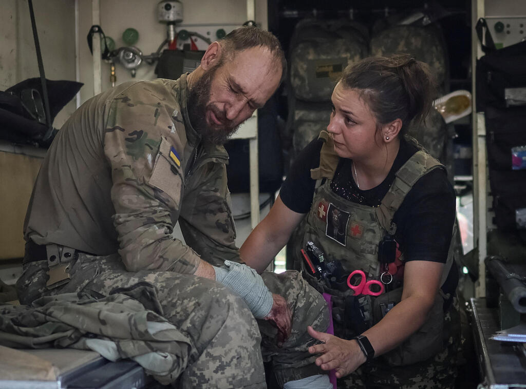 Ukrainian serviceman treated by paramedic after being wounded in fighting 