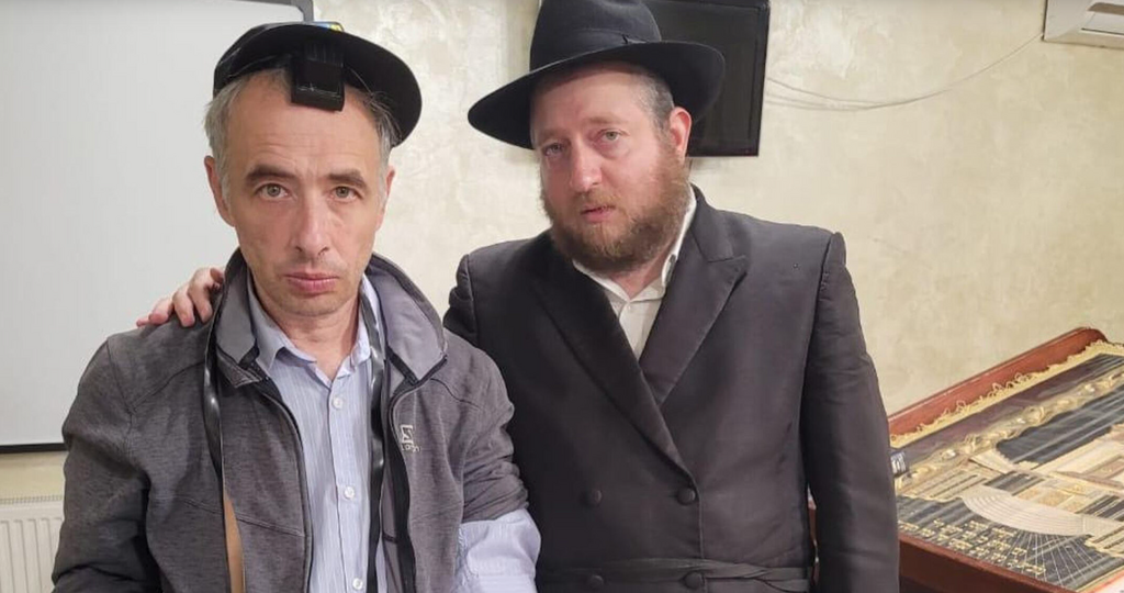 Rabbi Shaul Horowitz, right, meets a Jewish refugee attending service at the synagogue of Vinnytsia, Ukraine in June 2022 