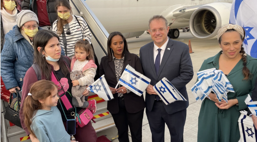 Israeli officials, including Aliyah and Integration Minister Pnina Tamano-Shata, center, greet refugees from Ukraine as they arrive at Israel’s Ben-Gurion Airport, March 6, 2022 