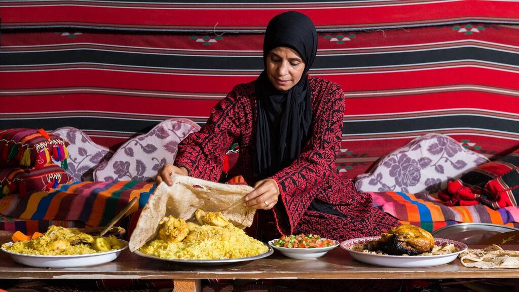 A resident of the Bedouin city of Rahat, Israel prepares mansaf, a traditional Arab dish 