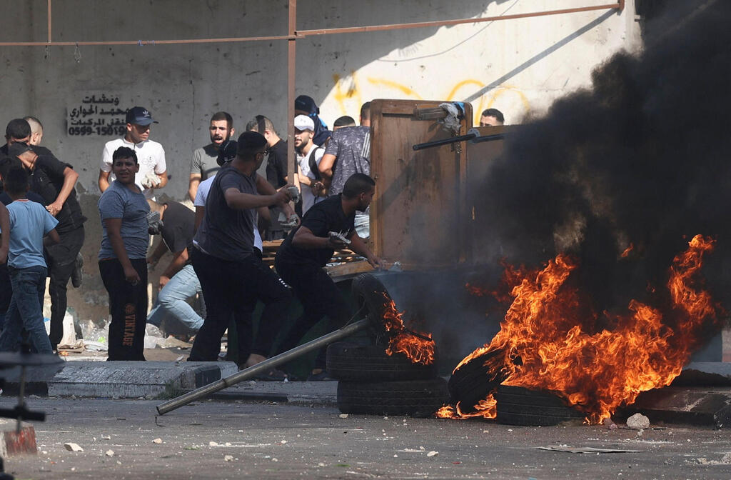 Palestinians clash with Israeli troops in Nablus on Tuesday 