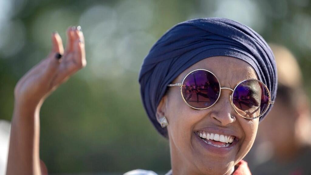 U.S. Rep. Ilhan Omar waves during a voter engagement event in Minneapolis 