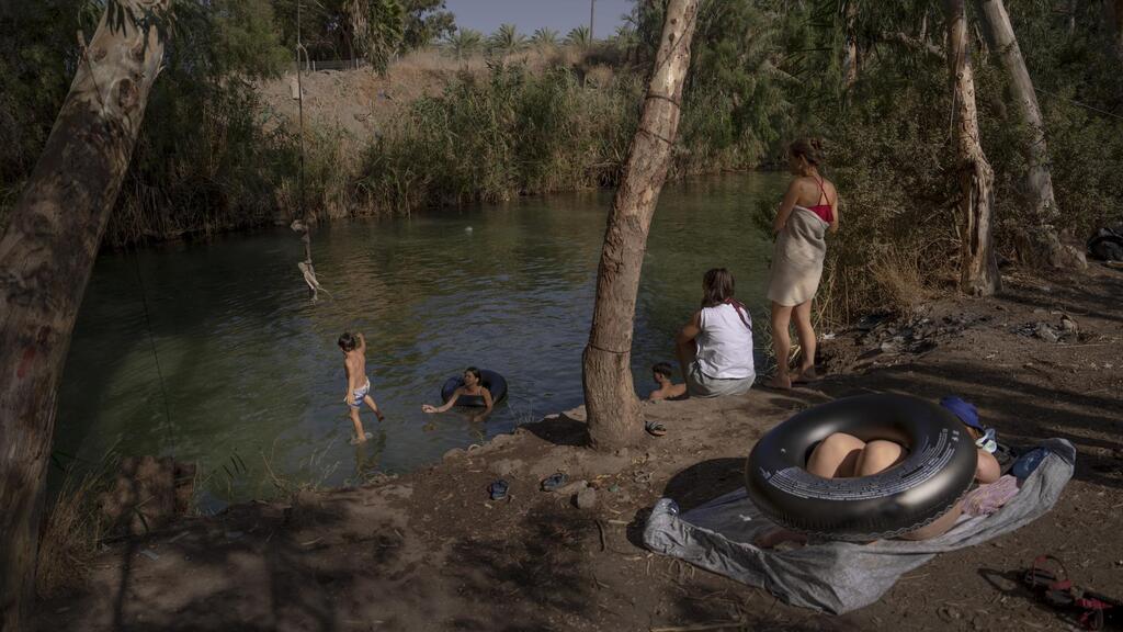 People spend the day at the Jordan River near Kibbutz Kinneret in northern Israel 
