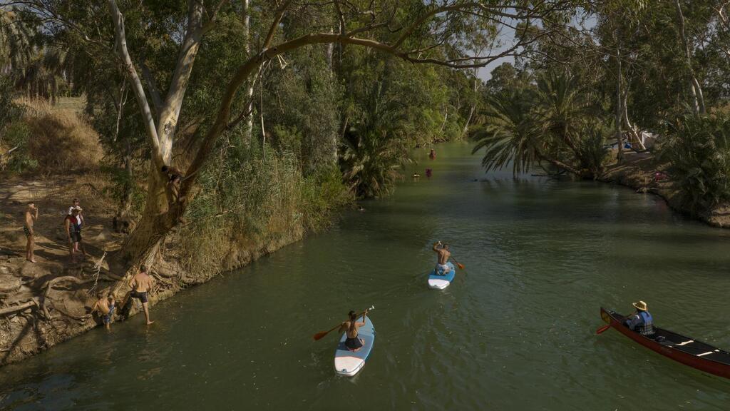 People spend the day at the Jordan River near Kibbutz Kinneret in northern Israel 