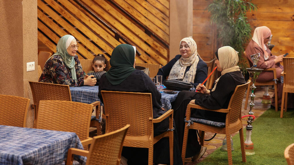 Palestinian women sit at a beach coffee shop in Gaza city, on July 2, 2022