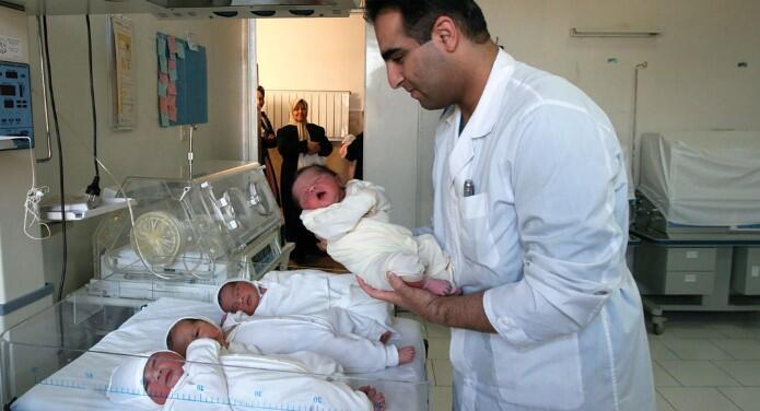 A Jewish doctor holds a newborn Muslim baby at the Jewish-owned Dr. Sapir Hospital and Charity Center 