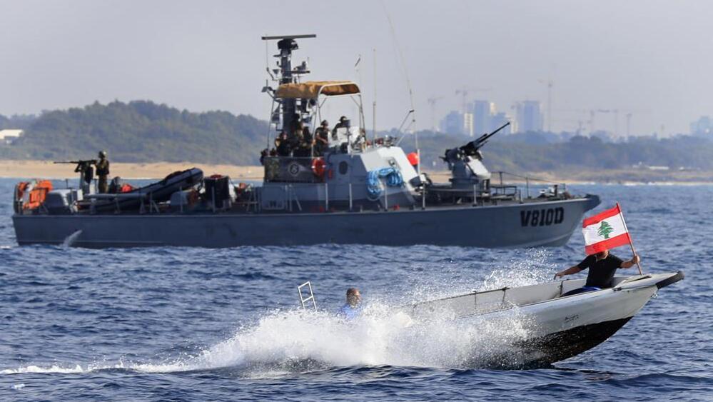 Lebanese protesters on a motorboat carry their national flag as they sail in front on an Israeli Navy vessel (Photo: AP) Lebanese protesters on a motorboat carry their national flag as they sail in front on an Israeli Navy vessel
