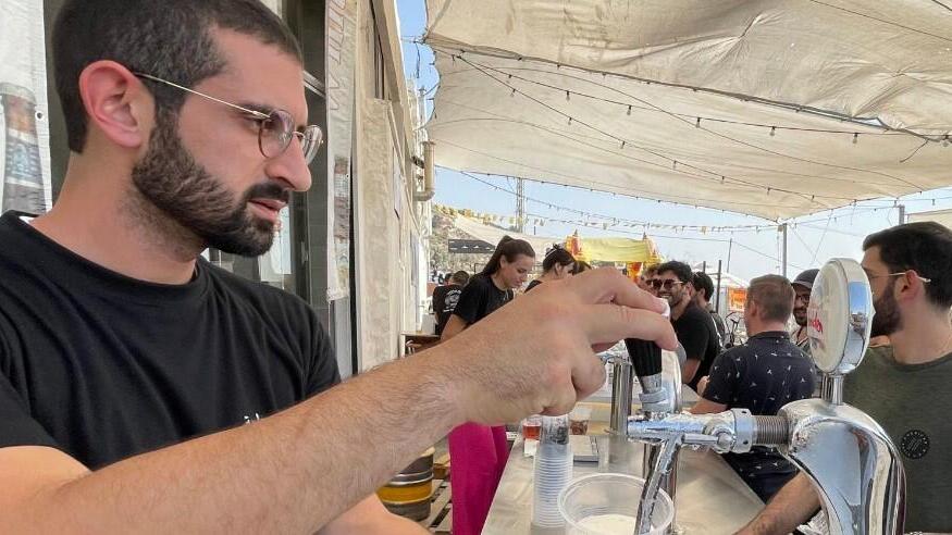 Canaan Khoury serves up a beer at his family's micro brewry in Taybe, in the West Bank 