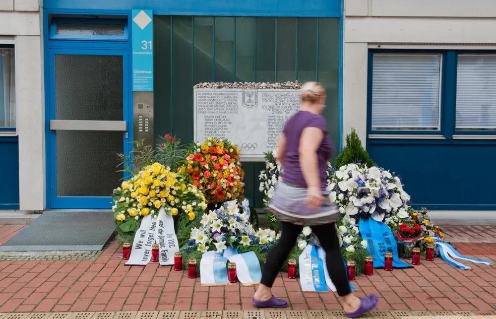 A woman passes by the commemoration plate for victims of the 1972 Munich Olympics massacre in front of the house in Connollystrasse 31, where the Israeli team stayed during the Olympic Games in Munich, southern Germany, on September 5, 2012 