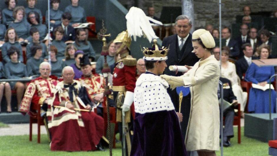 Prince Charles  kneels before his mother, Britain's Queen Eizabeth II 
