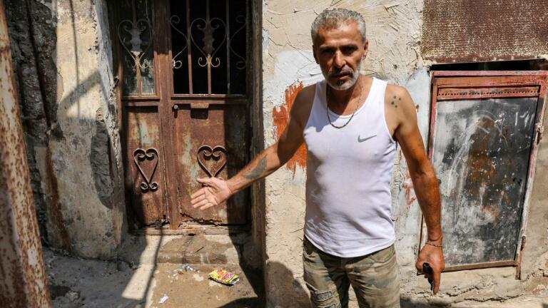 Najib al-Khatib, 52, indicates a place that was laden with corpses after the Sabra and Shatila massacre 40 years ago 