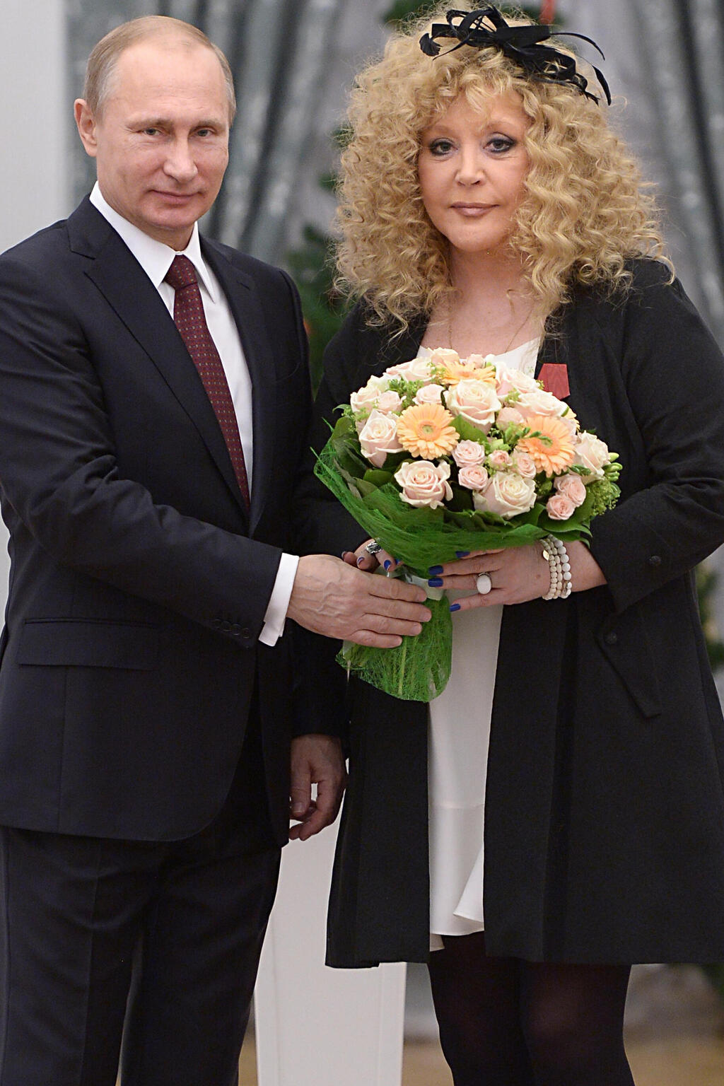 Russian President Vladimir Putin, left, and Russian pop singer Alla Pugacheva pose for a photo during an awards ceremony in Moscow's Kremlin