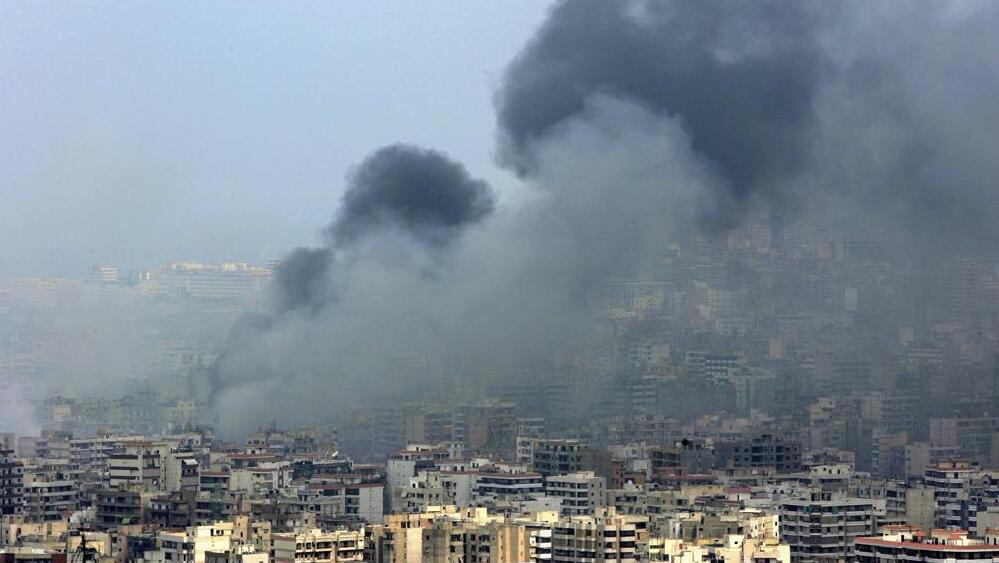 Black smoke rises from the demolished headquarters of Hezbollah in the suburbs of Beirut, Lebanon, following Israeli air strikes, July 16, 2006 
