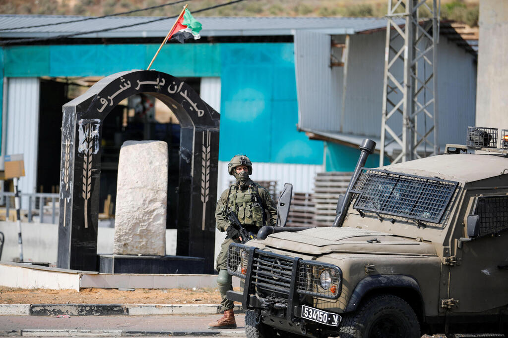 IDF soldier stands guard near site of shooting attack in Nablus 