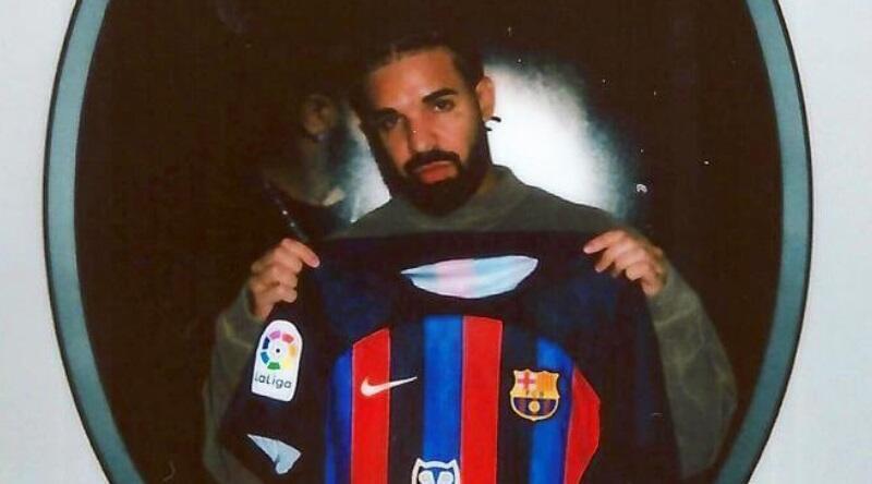 Drake holding a Barcelona shirt 