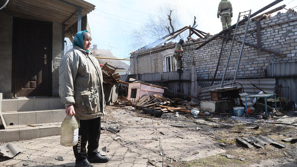 Elderly woman stand amid destruction in Eastern Ukraine 