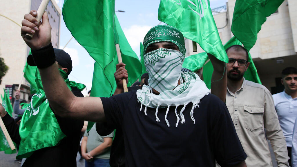 Palestinian demonstrators loyal to the Islamic movement of Hamas march during a protest in the West Bank city of Hebron