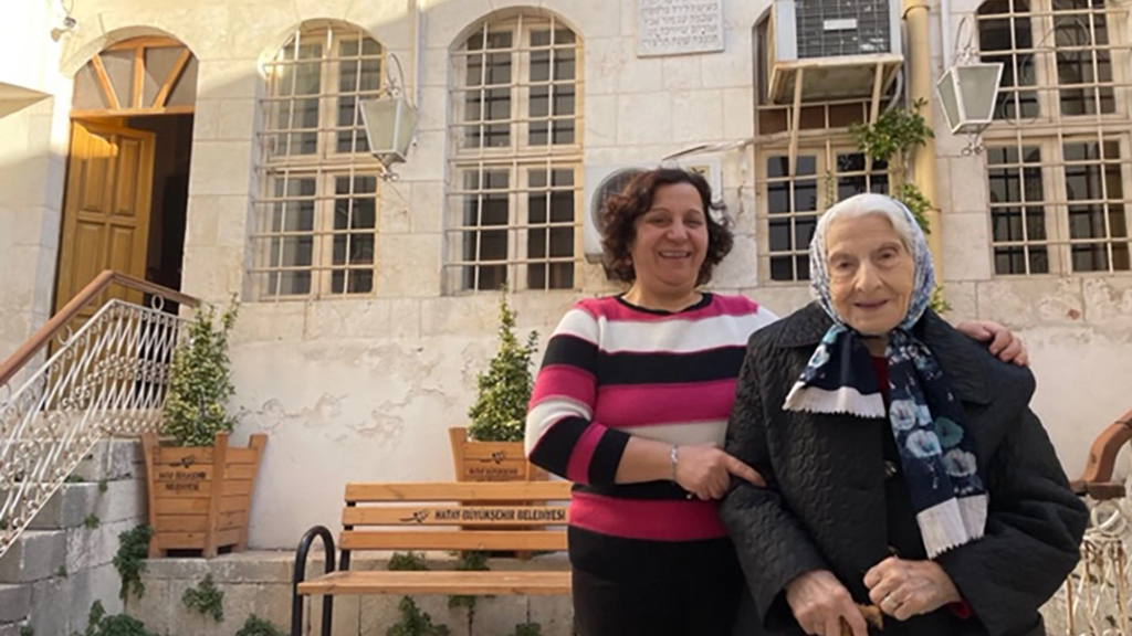 Olga stands with her husband’s 90-year-old mother, Adile, in Antakya 