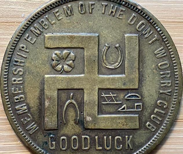 In this photo provided by Holocaust researcher Jeff Kelman in November 2022, the swastika is seen on a coupon-type store token made before the Nazi Party adopted the symbol. This is part of Kelman's collection, which he says shows the "regular and innocuous use of the swastika as a symbol of good fortune in the West, prior to the Nazi use of the similar-looking hakenkreuz" 
