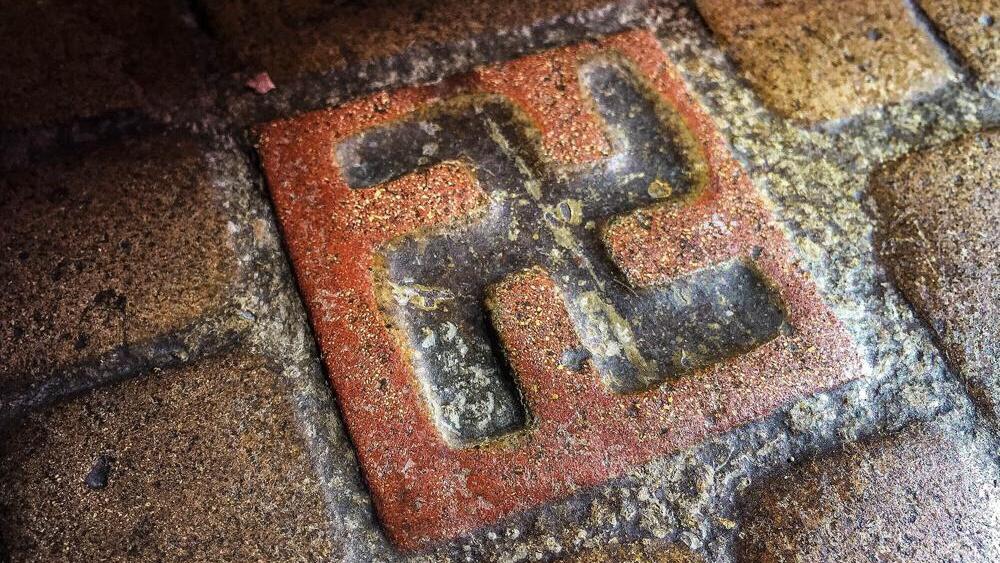 One of about 60 floor tiles emblazoned with swastika-style crosses in the entrance to the Longview Community Church in Longview, Wash., is seen on March 3, 2016. A Longview church established in 1925 bears tiles with symbols that were once seen as a sign of good fortune, but are now more closely associated with terror 