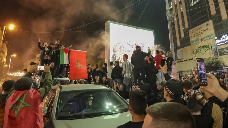Palestinians celebrate Morocco's win over Portugal in the streets of the West Bank city of Hebron after the Qatar 2022 World Cup quarter-final football match between Morocco and Portugal 