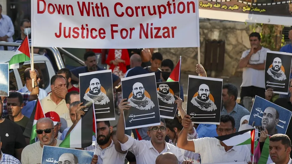 Palestinian protesters rally in the West Bank city of Ramallah, denouncing the Palestinian Authority in the aftermath of the death of activist Nizar Banat while in the custody of PA security forces 