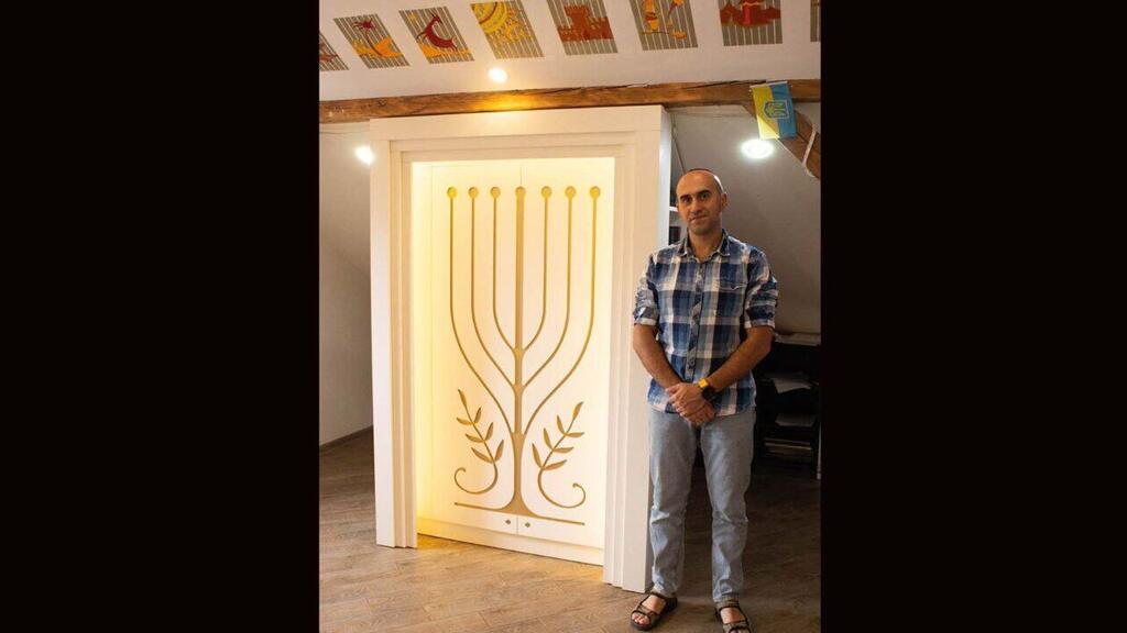 Lev Kleiman is shown with his community’s Torah ark 