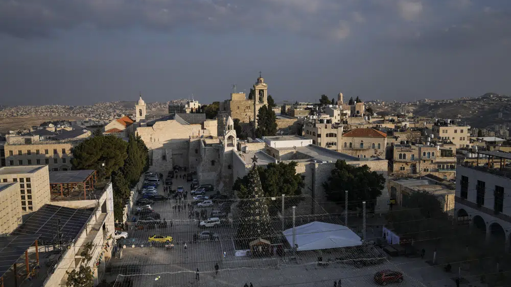 A Christmas tree decorates Manger Square, adjacent to the Church of the Nativity, traditionally believed by Christians to be the birthplace of Jesus Christ, ahead of Christmas, in the West Bank city of Bethlehem, Monday, Dec. 5, 2022 