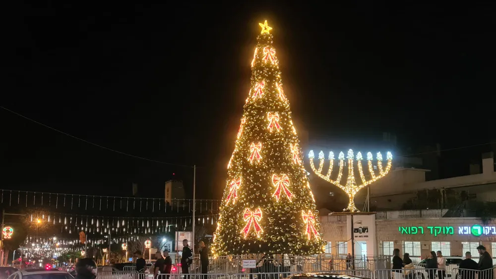 A Christmas tree next to a Hanukkah candlestick in Haifa, Israel, during the Hag HaHagim festival 