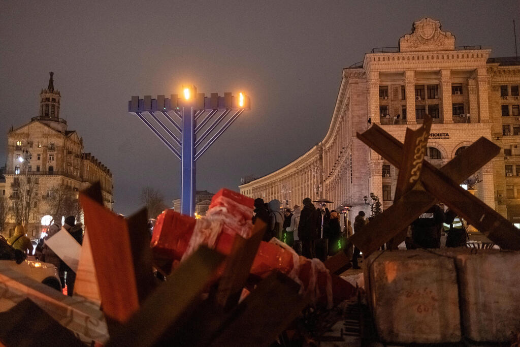 Anti-tank hedgehogs are seen next to a giant menorah in Kyiv 
